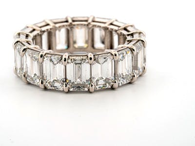 Emerald cut gallery-style eternity band set in platinum