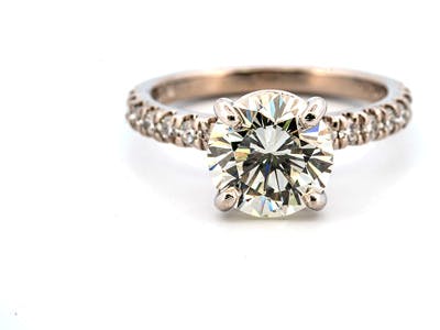 Round diamond engagement ring with side round brilliant diamonds graded by GIA