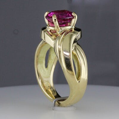 Side view of 18 karat yellow gold pink sapphire ring