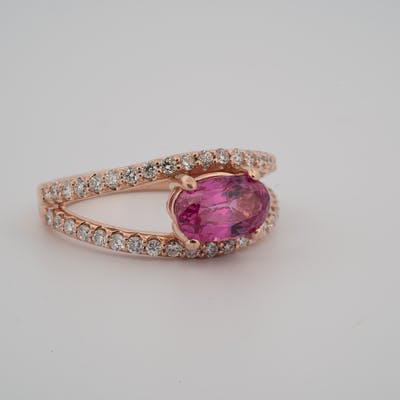 Side view of 14 karat rose gold pink sapphire ring with diamond accents