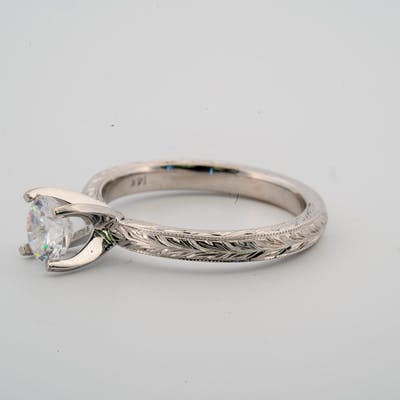 Side view of gold or platinum vintage style engagement solitaire ring